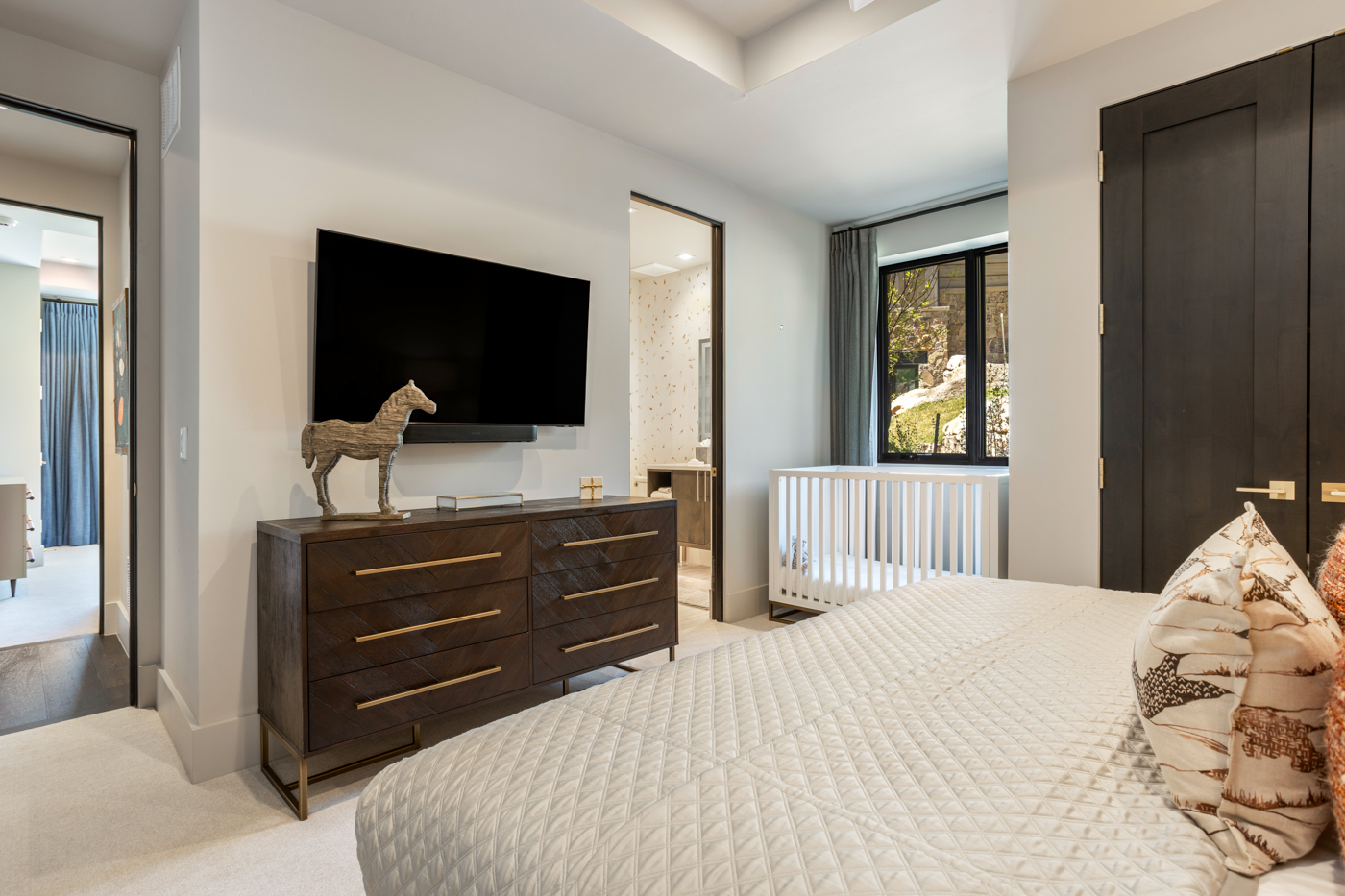 Bedroom with crib and en-suite beyond
