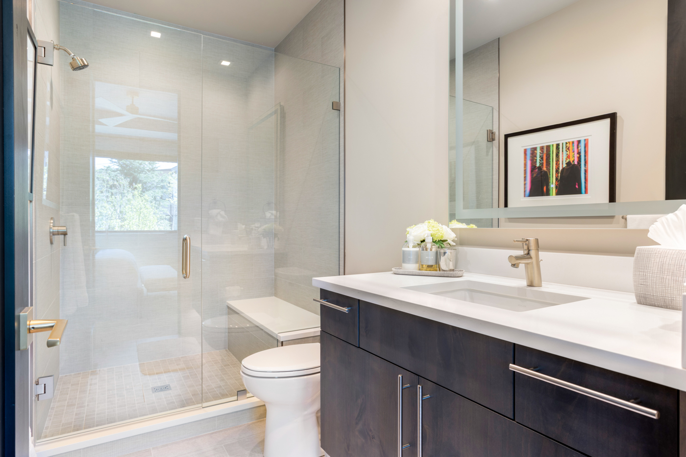 Walk-in glass shower with bench and vanity