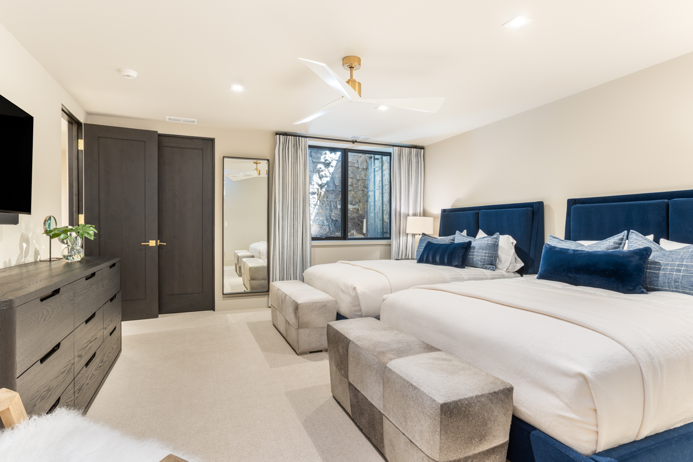 Double queen guest suite with navy headboards