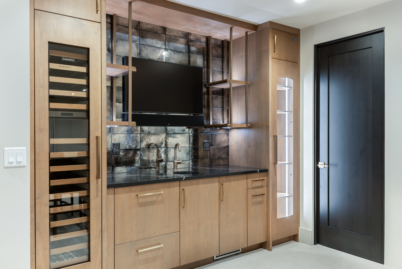 Bar with antiqued mirror tile and Sub-Zero wine storage
